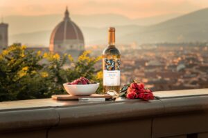 A captivating view of Florence with wine, strawberries, and roses, epitomizing romance.